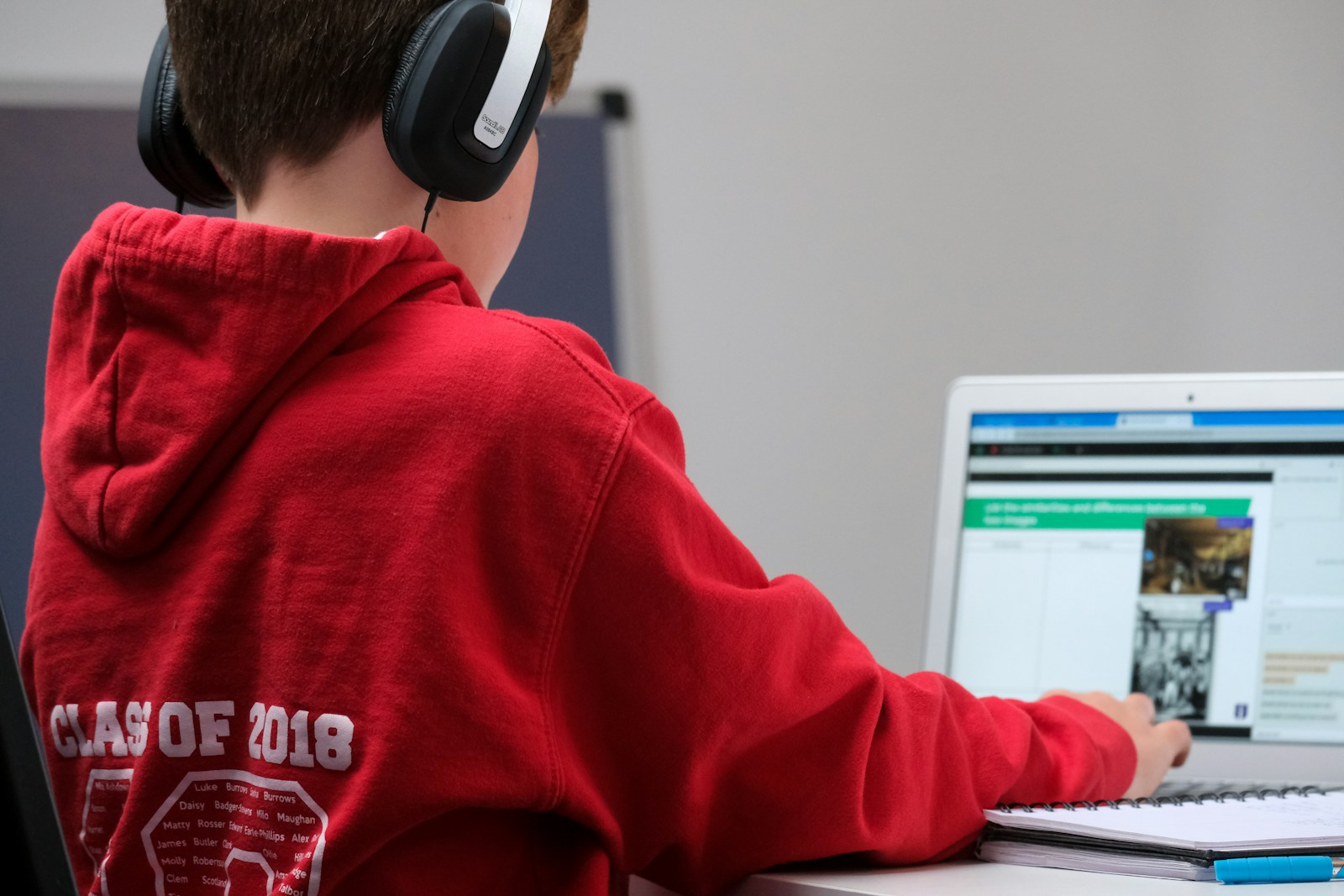 Student preparing for a TOEFL English test on a laptop with headphones